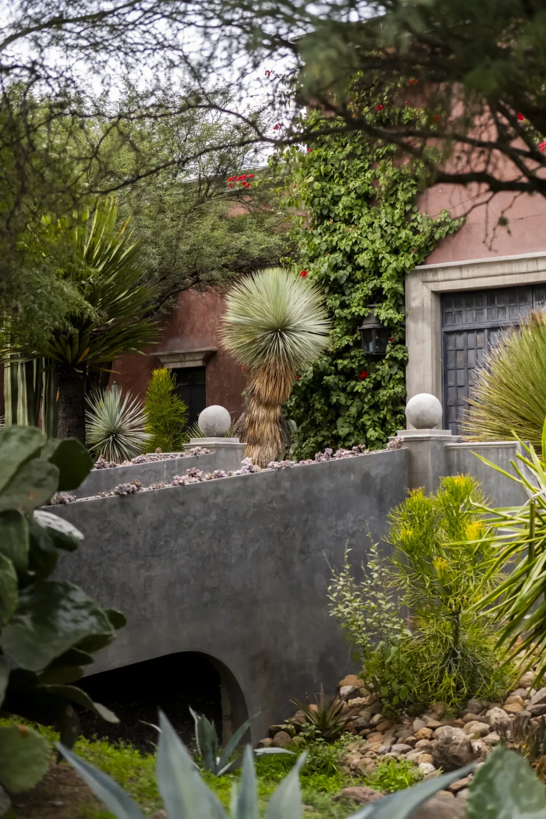 The bridge over the arroyo and, behind it, the house among the mesquites.