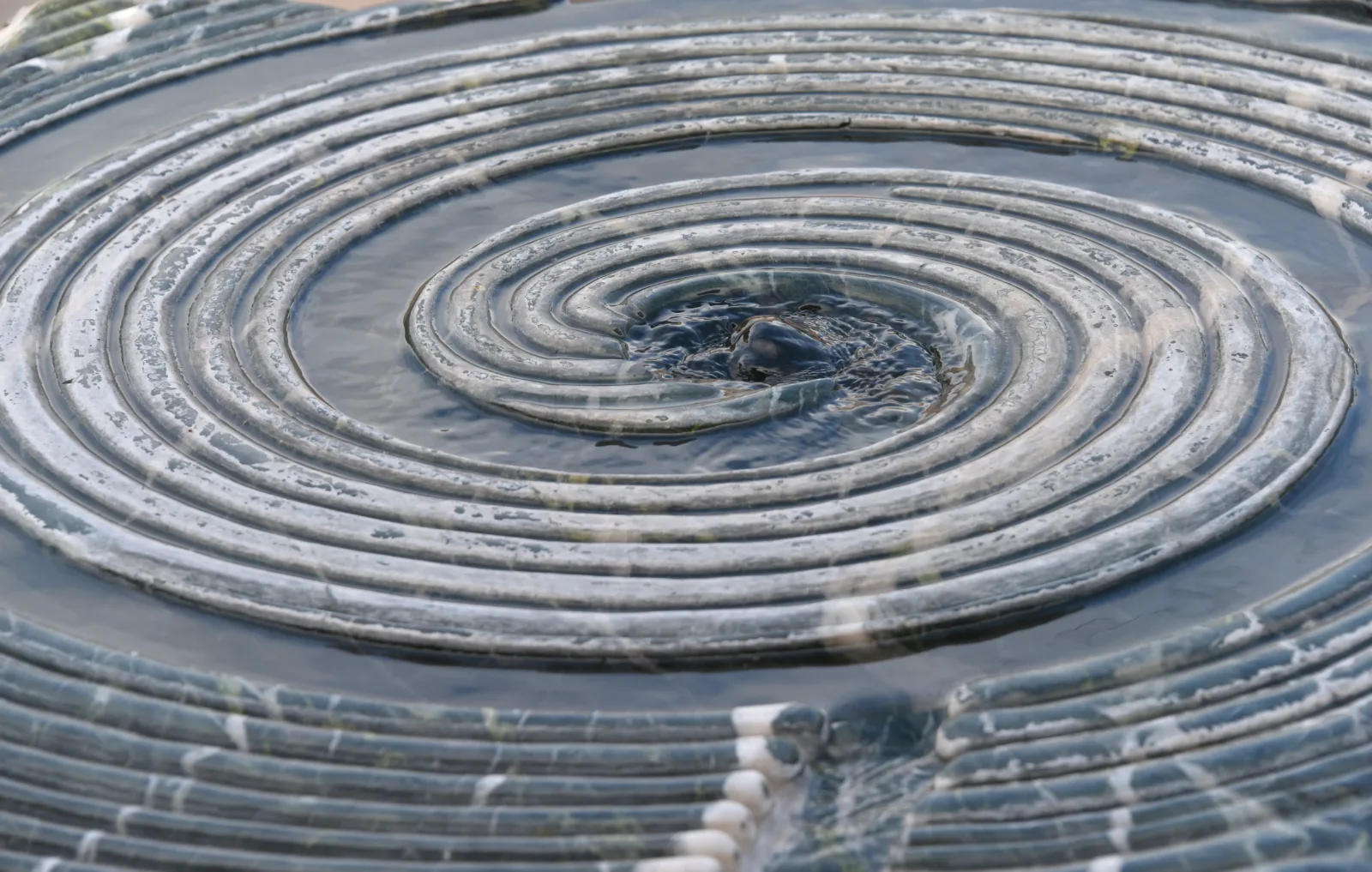 A fountain: a stone spiral with water.